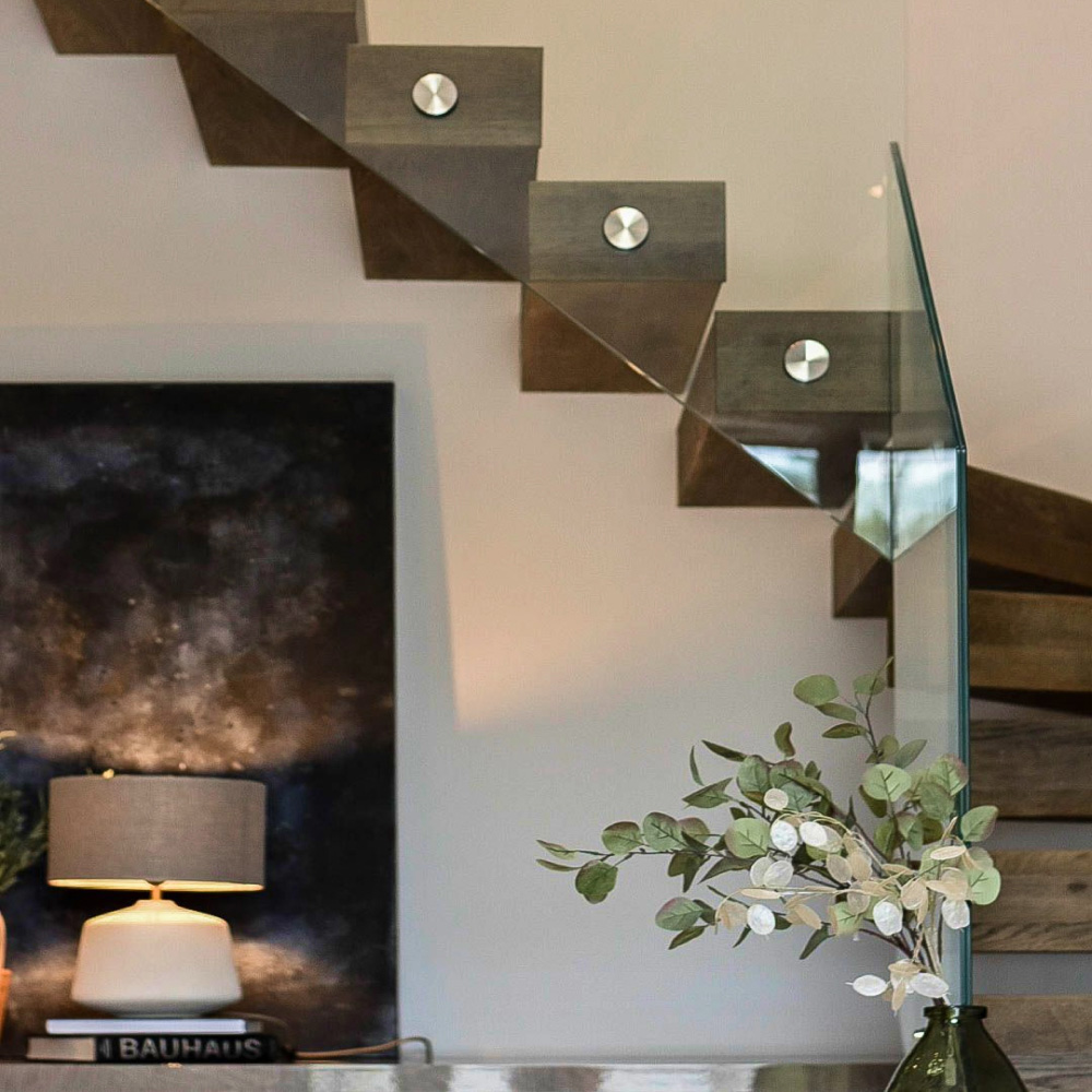 Interior of a timber frame home with bespoke windows and staircase