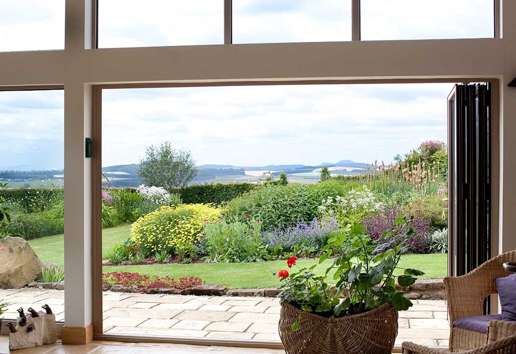 Open-plan living space with large windows overlooking the garden