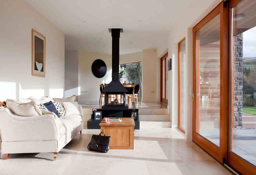 Bright modern living space with a central wood-burning stove