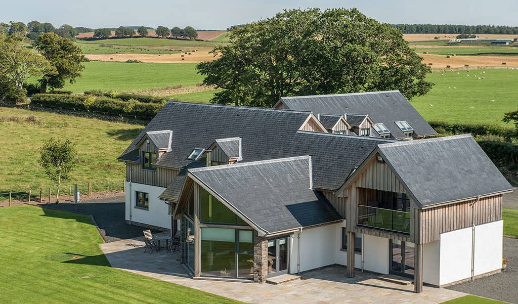 Modern timber frame home exterior in a countryside setting