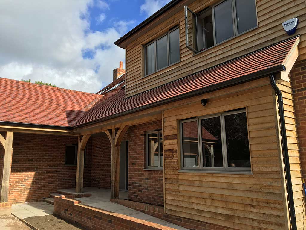 Self-build home exterior finished in timber and brick