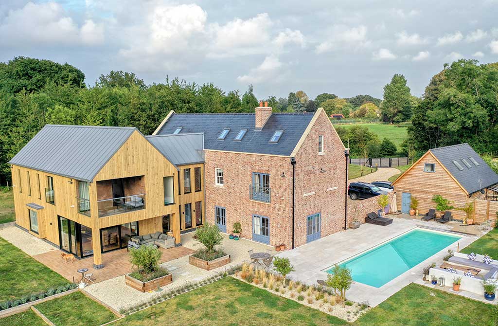 Self-build timber frame home rear view with pool