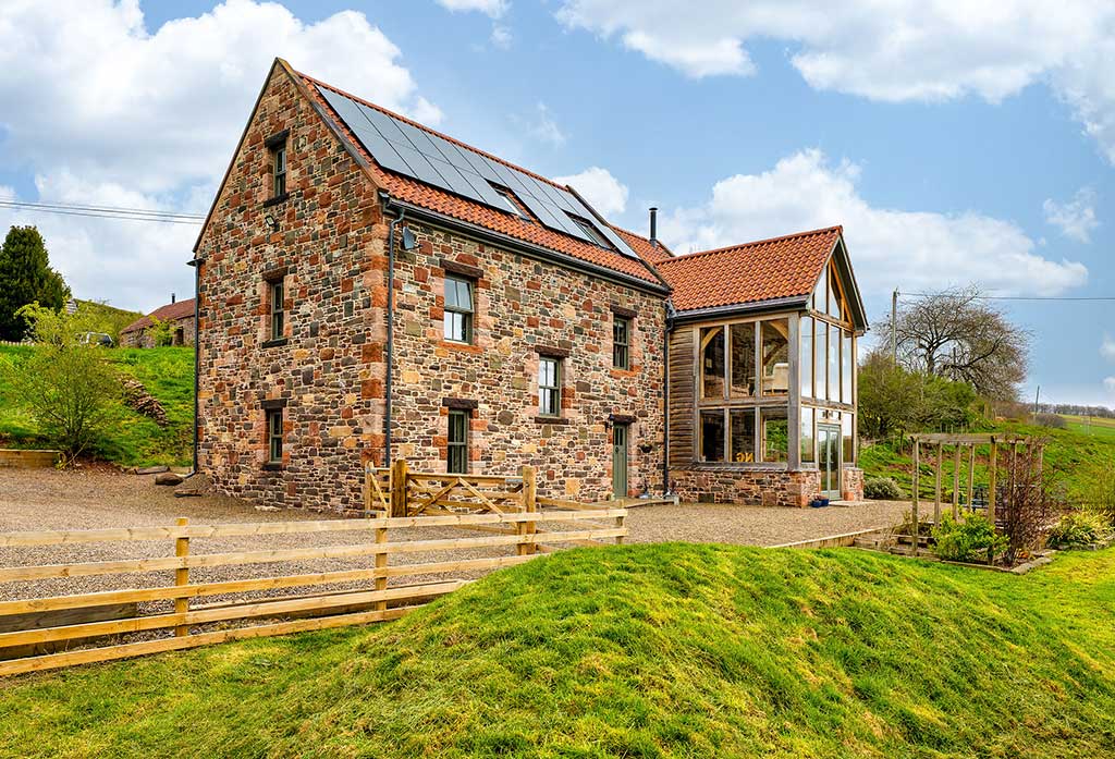 Stone cladding and oak frame timber frame home exterior