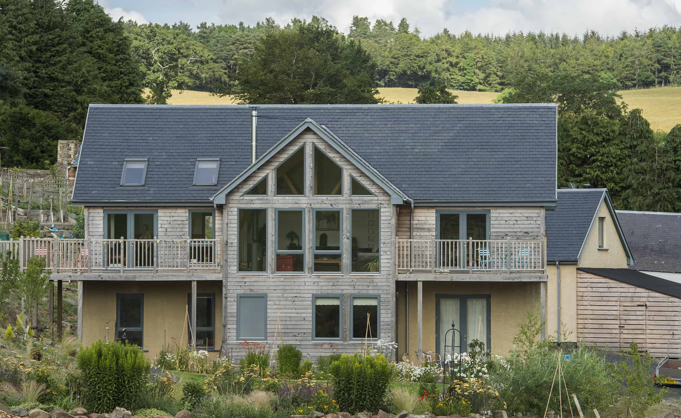 Timber-clad and rendered self-build home exterior