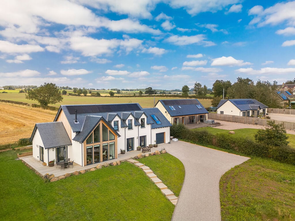 Timber frame self-build exterior with landscaped garden setting