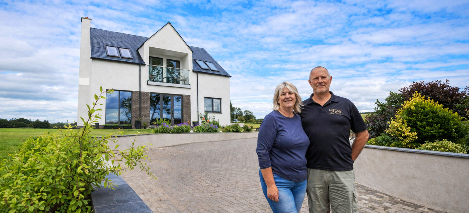 Couple standing outside a completed self-build home