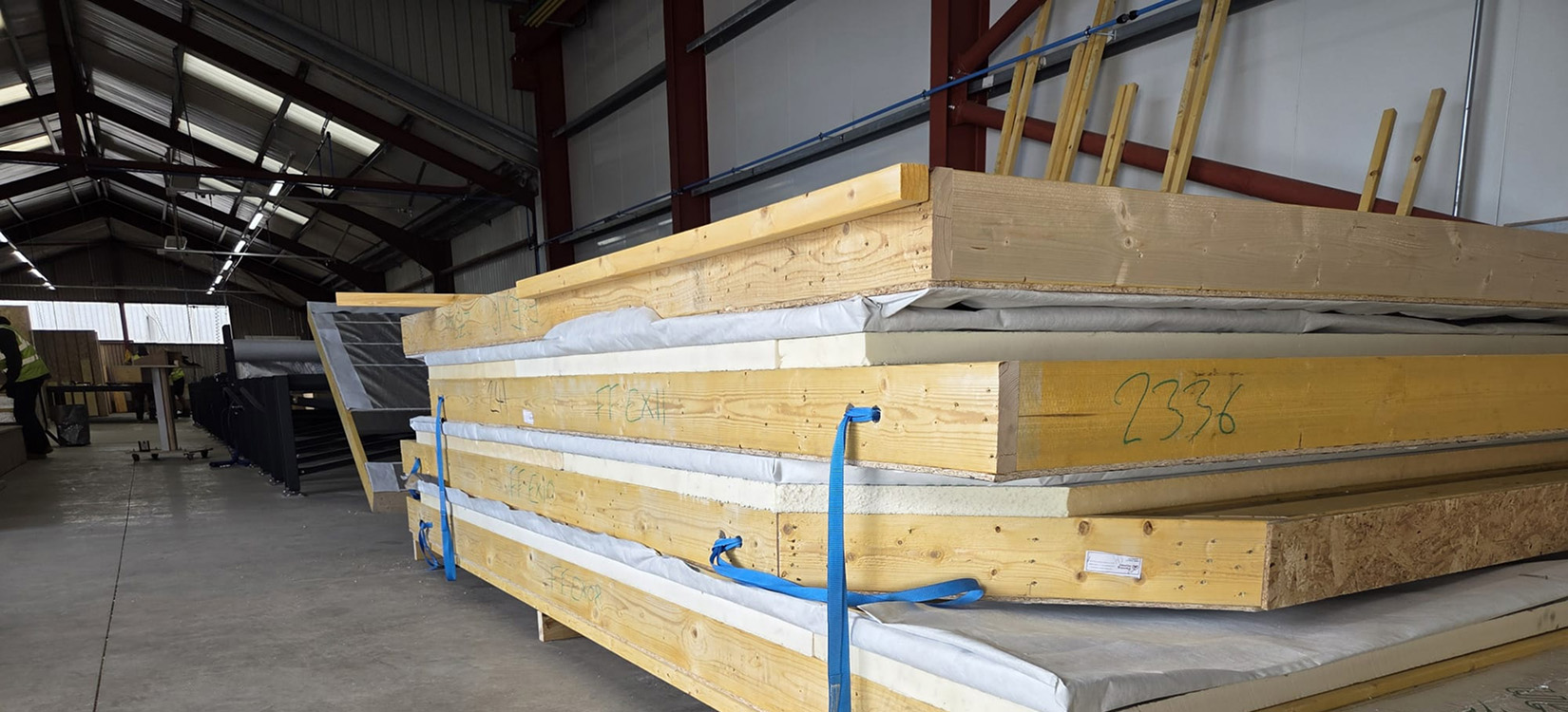 On-site assembly of timber frame panels for a custom home in Ayr