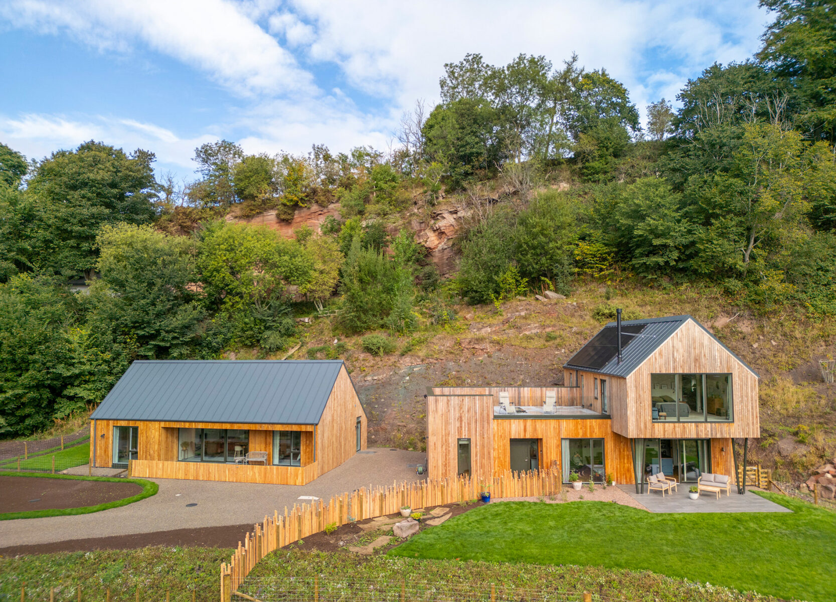 The Quarry home and annex built into a sandstone cliff landscape