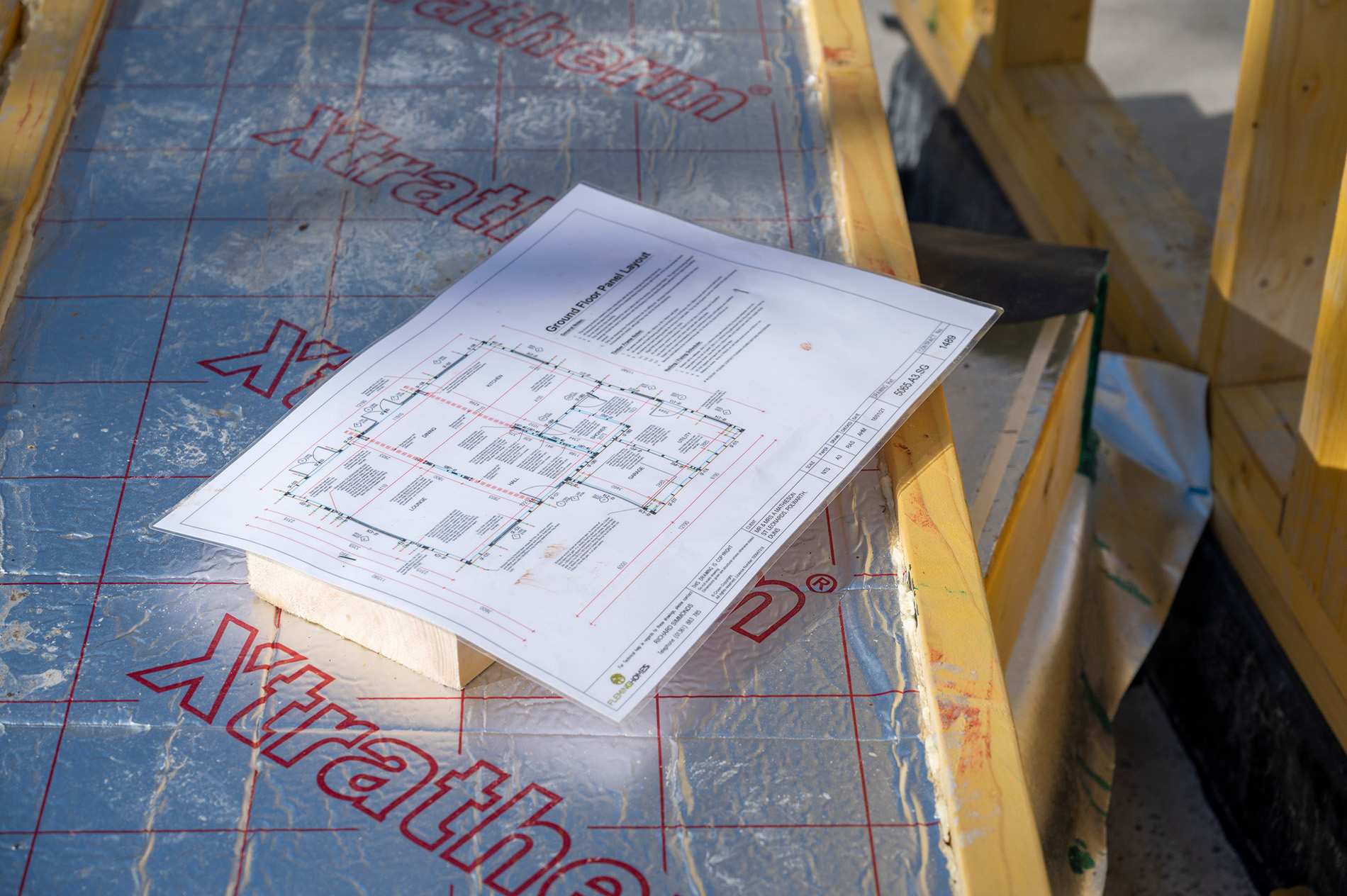 Fleming Homes team reviewing self-build design drawings before fabrication